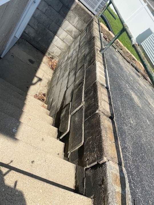 A set of stairs leading up to a brick wall