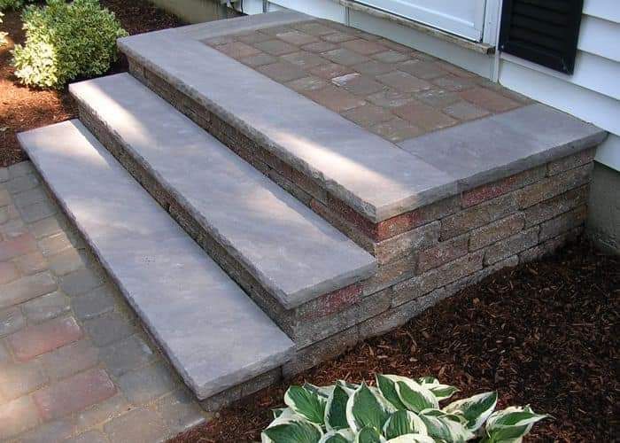 A set of steps leading up to a porch of a house.