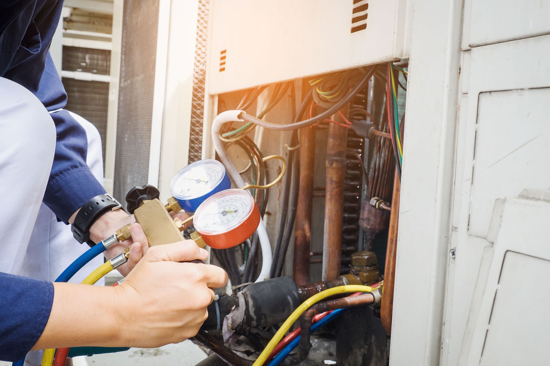 A man is working on a commercial boiler