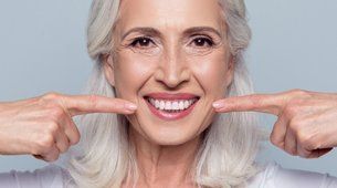 Smiling woman after surgical technique on teeth