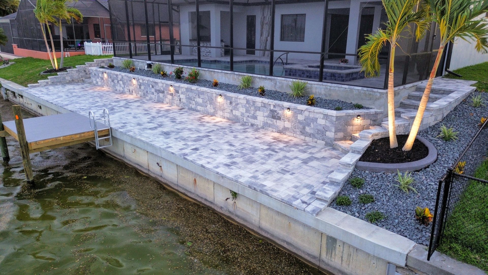 A large house is sitting next to a body of water.