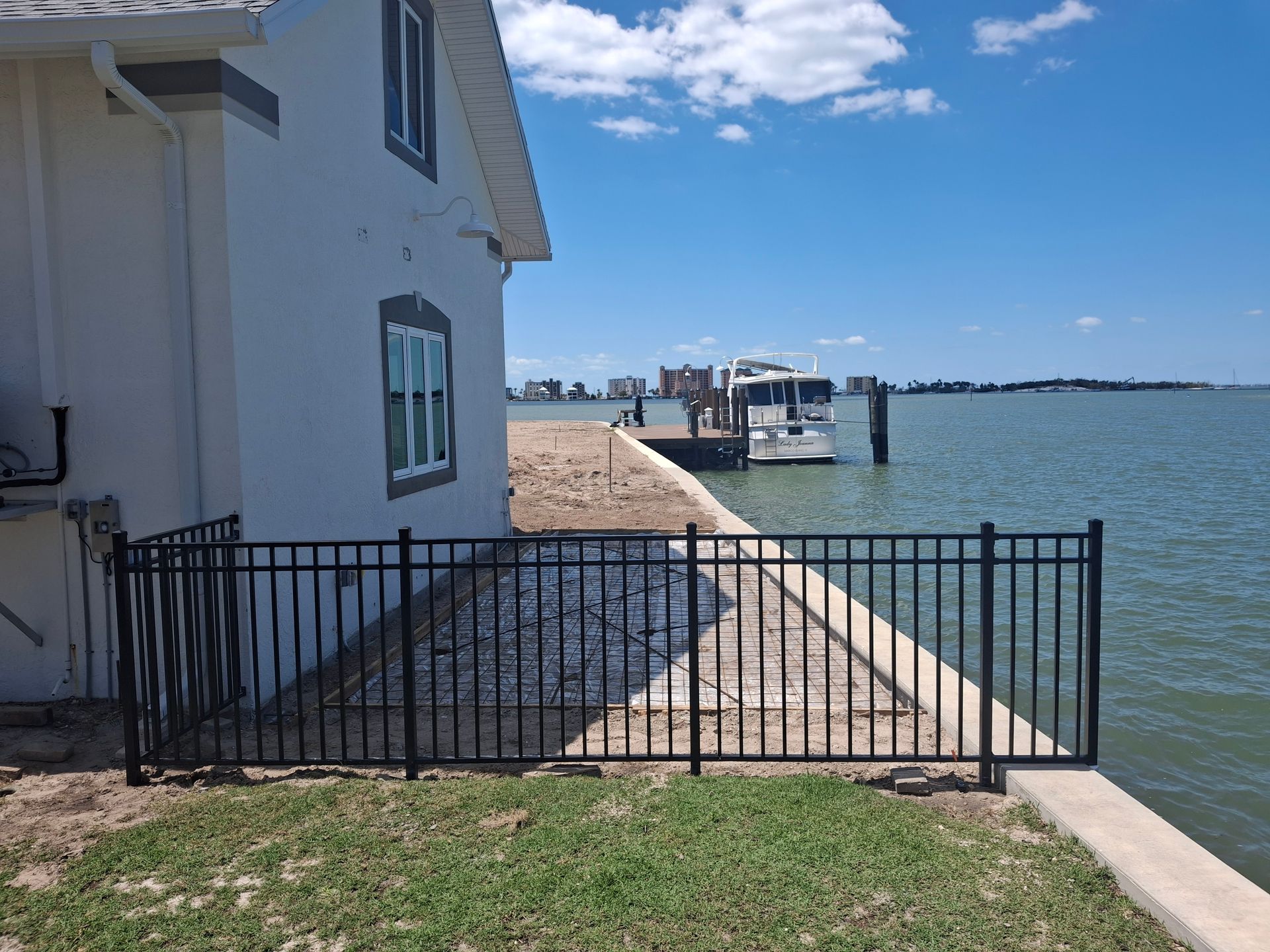 A boat is docked at a dock next to a house