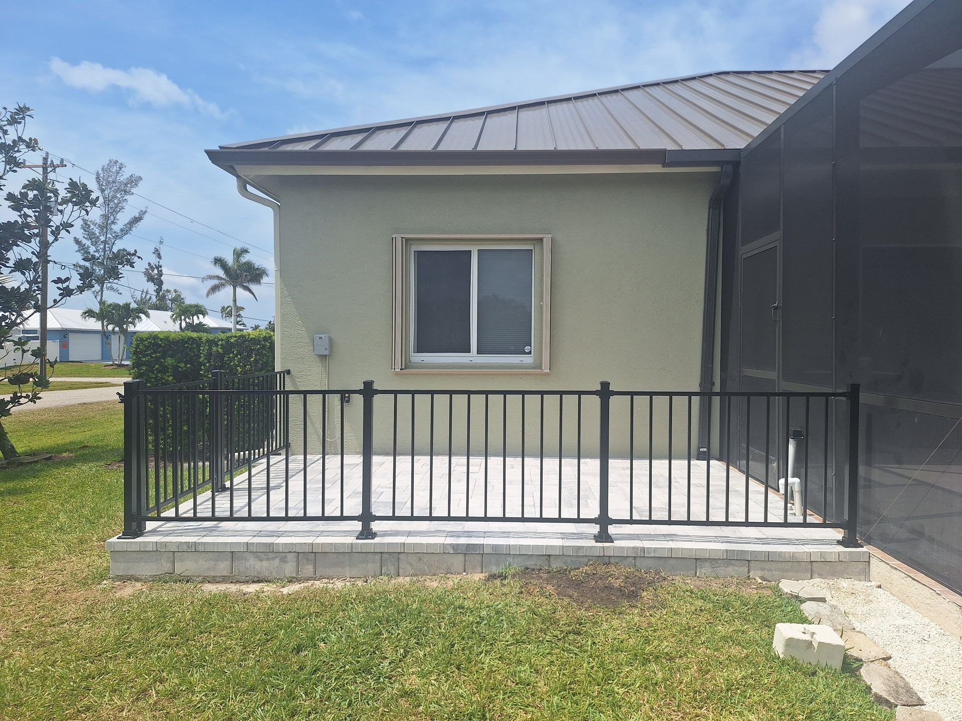 A small house with a fence around it and a window.