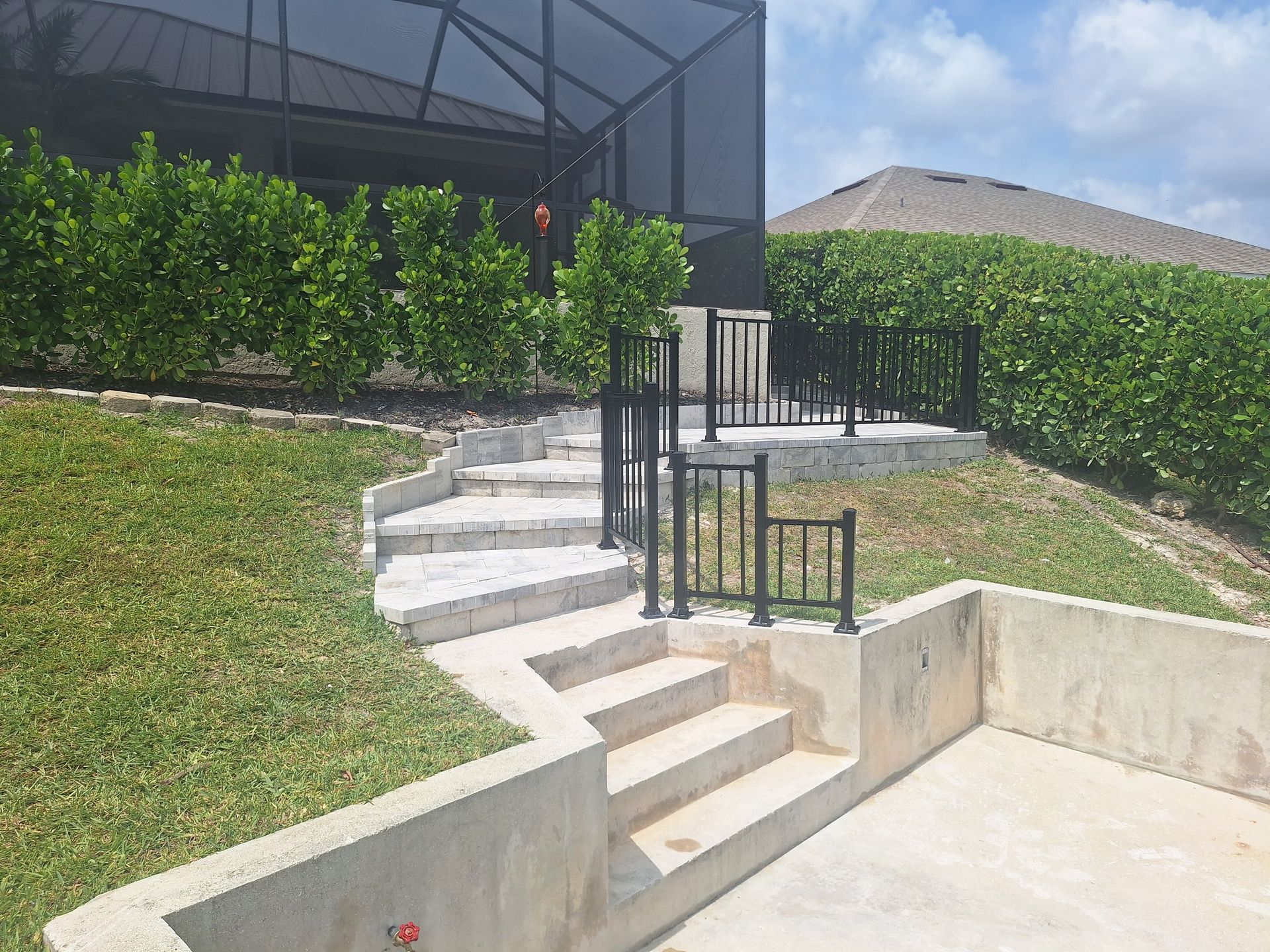 A set of stairs leading up to a screened in porch.