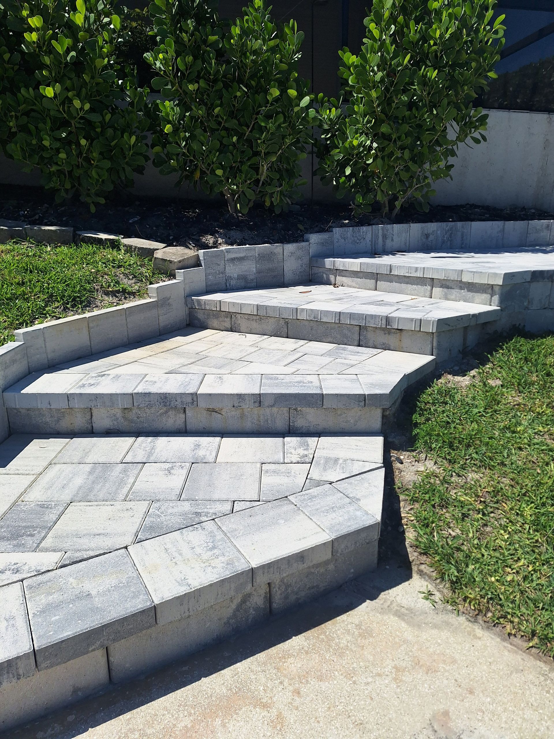 A set of stone steps leading up to a grassy area