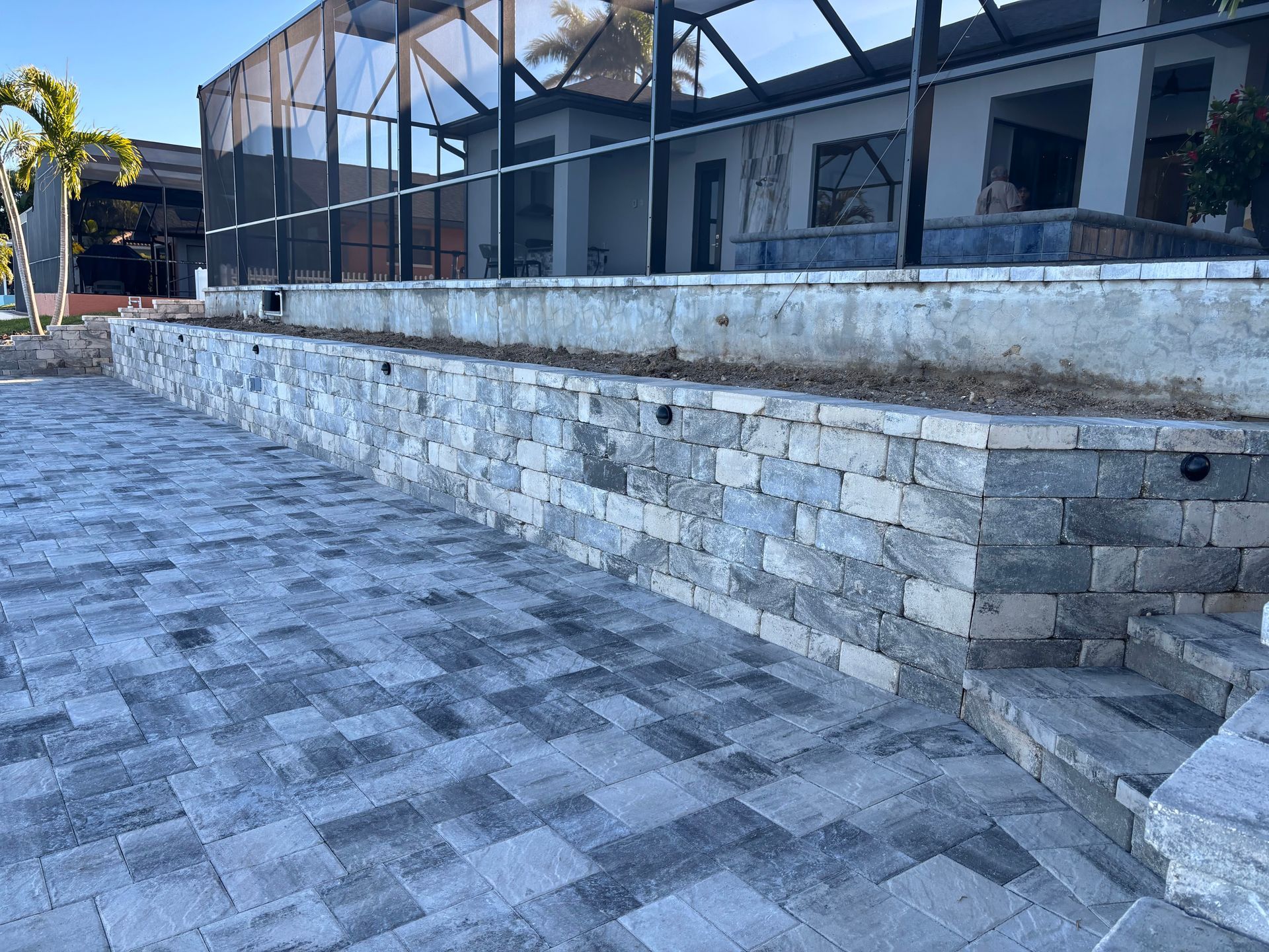 A brick wall is being built in front of a house.