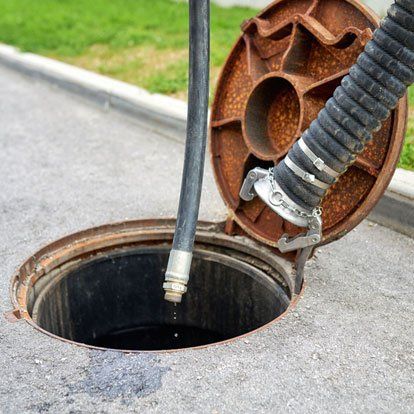 Cleaning sludge from septic system.