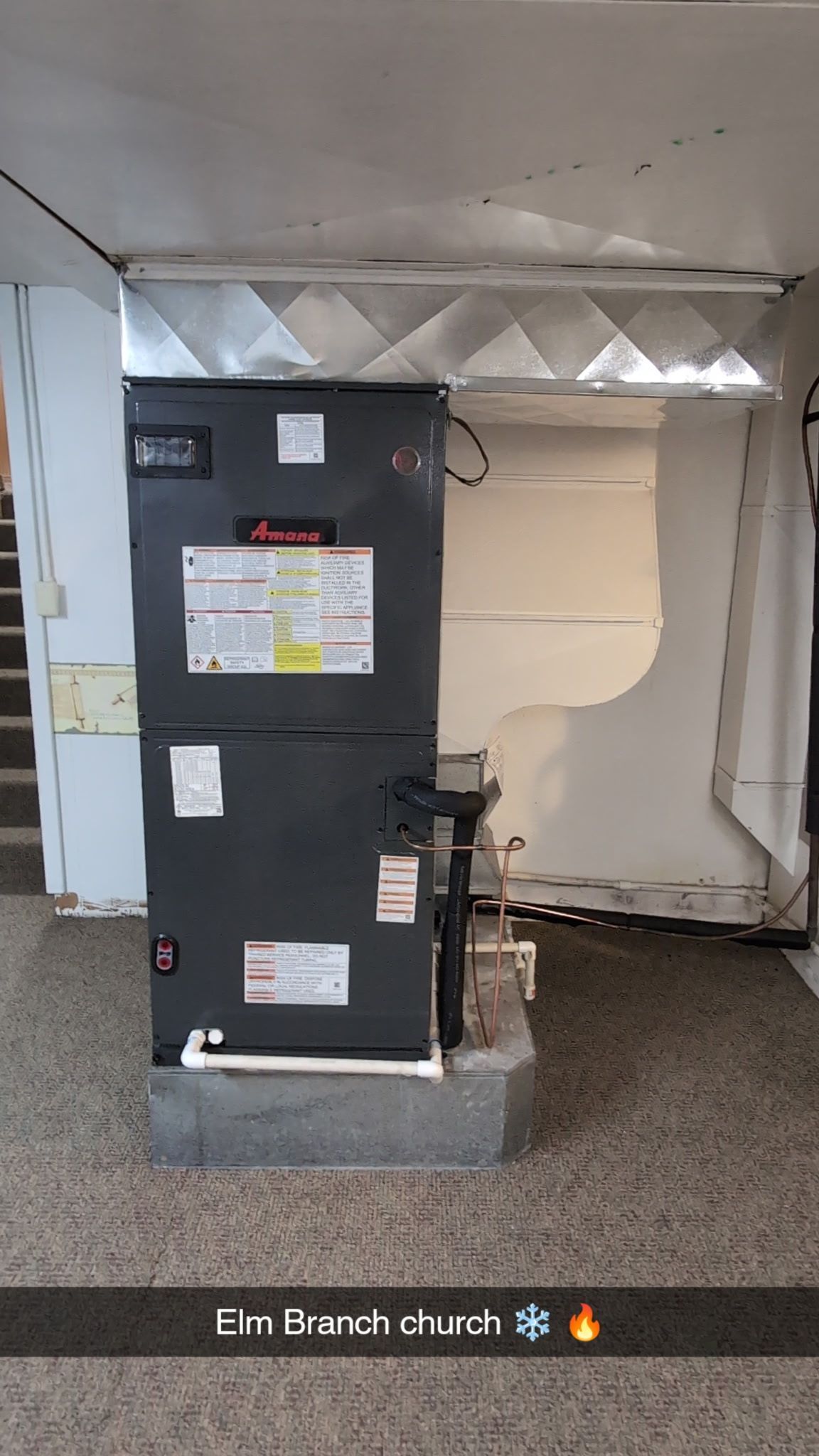 furnace unit in a room with ductwork, on a concrete base