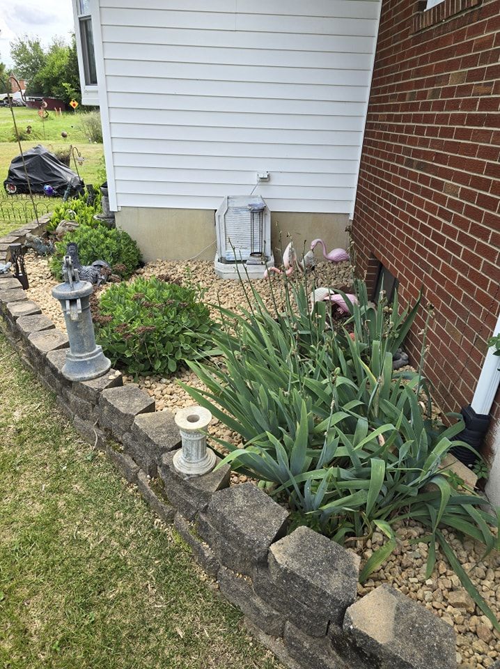 A brick house with a garden in front of it.