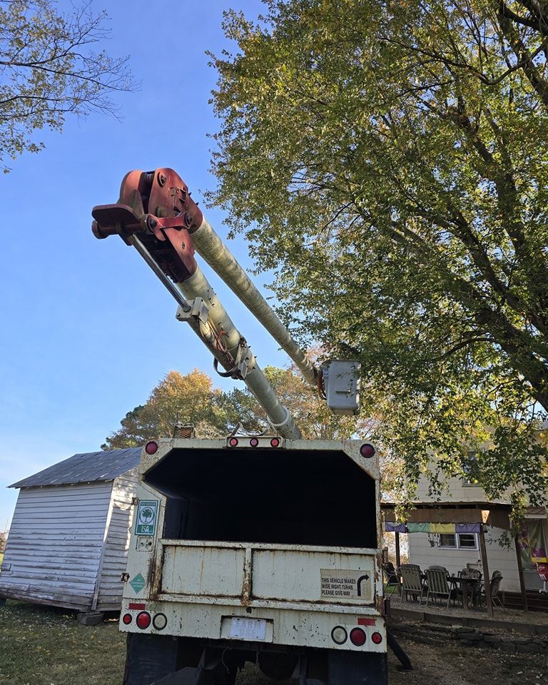 A white truck with a crane attached to the back of it