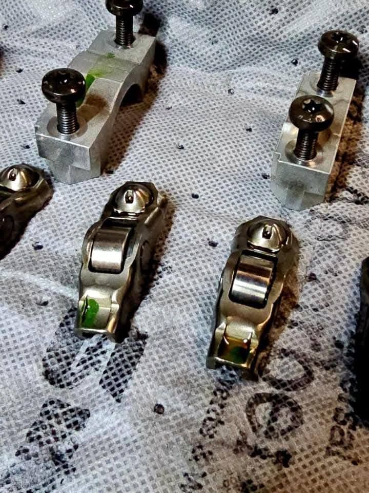 Close-up of metal connectors and clips on a patterned fabric surface.