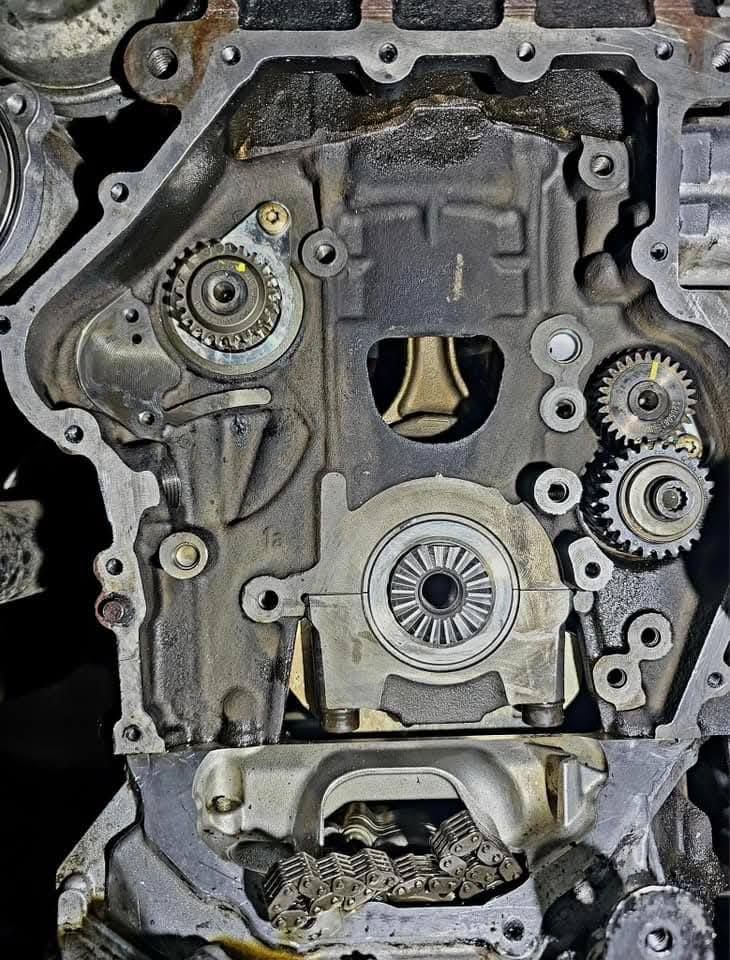 Engine transmission housing with exposed gears and clutch components in a metal case