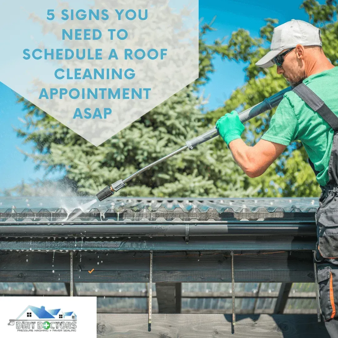 Roof cleaner spraying a gutter on a house under text: “5 signs you need to schedule a roof cleaning appointment ASAP.”