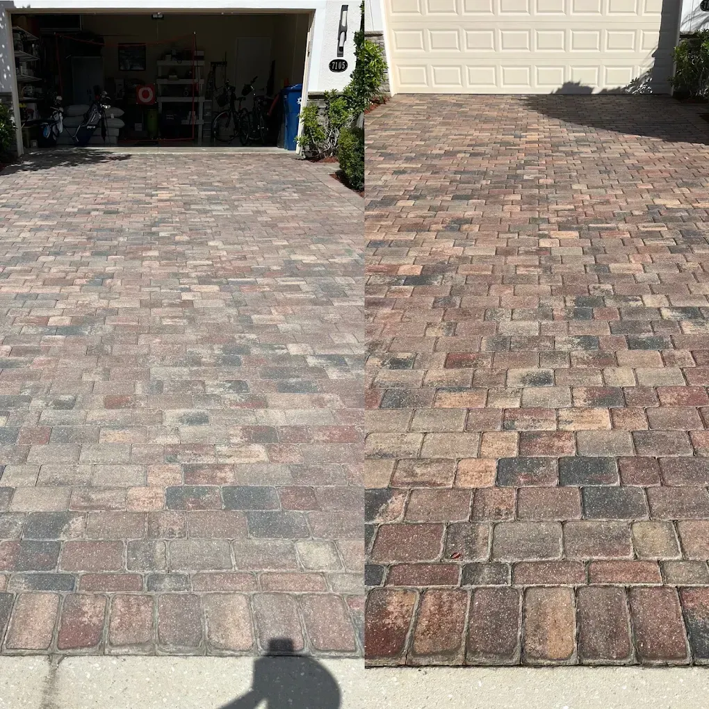 Split view of a brick driveway, showing faded left side and darker, newer right side near a garage.