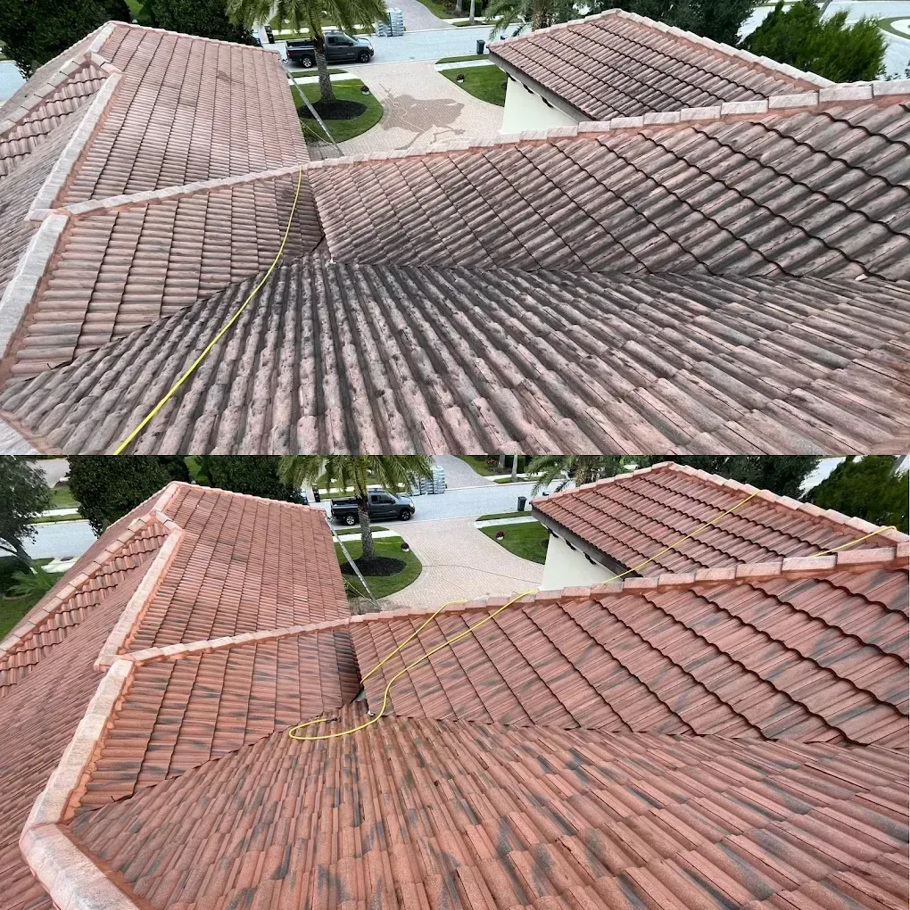 Aerial view of tiled residential rooftops and driveways in a suburban neighborhood.