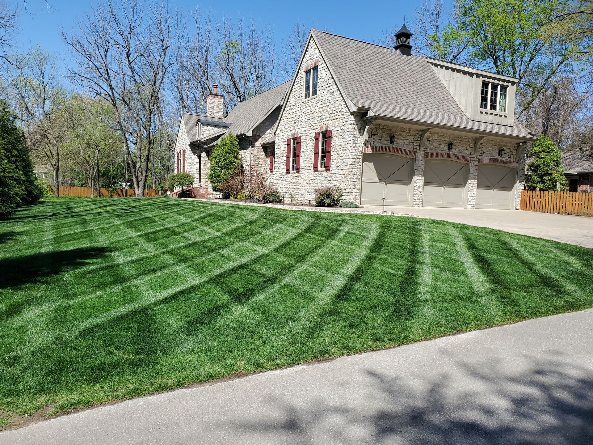A large house with a lush green lawn in front of it.