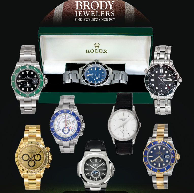 Several rolex watches are displayed in front of a brody jewelers box