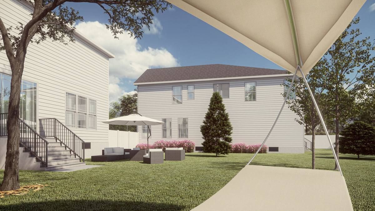 Backyard patio with white house, lawn, umbrella canopy, and outdoor seating