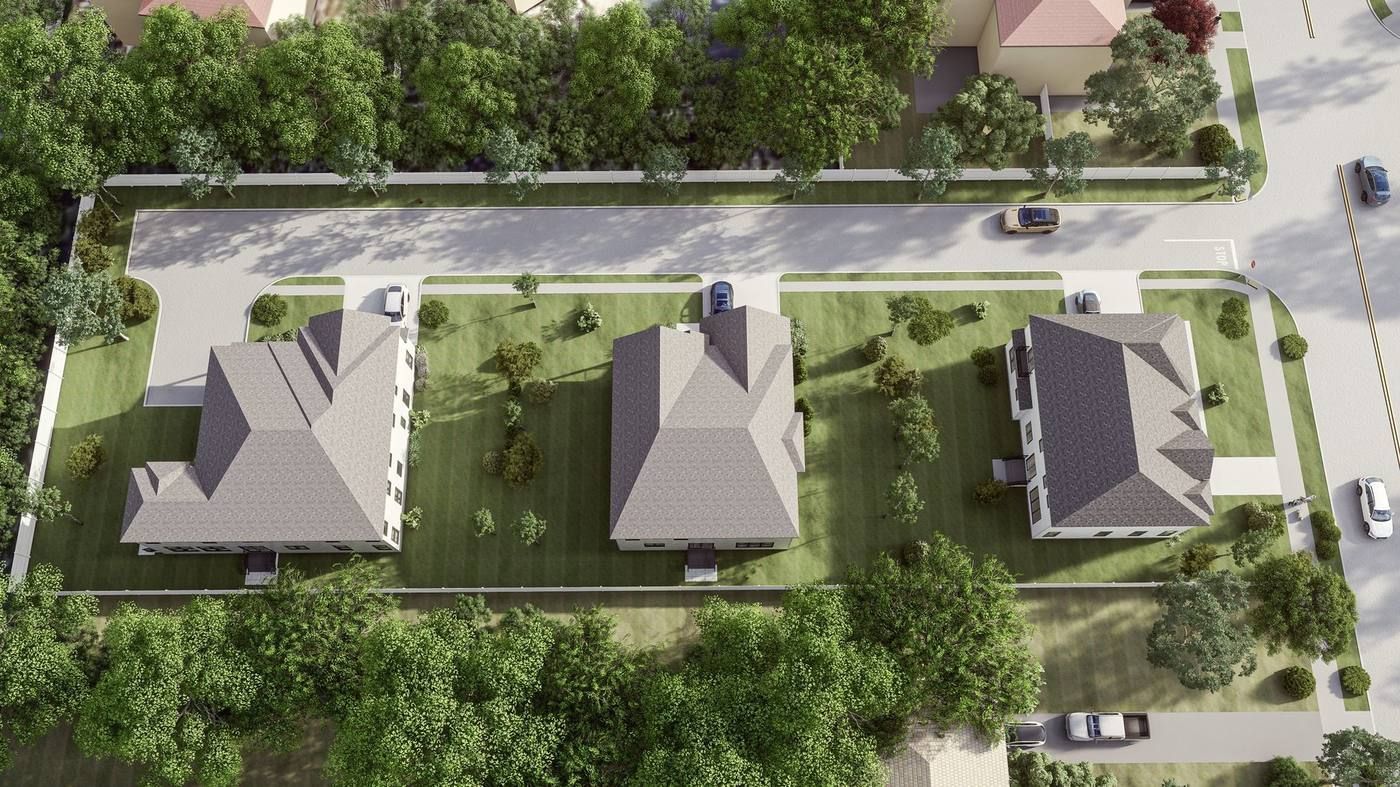 Aerial view of three houses along a residential street, surrounded by trees and greenery.