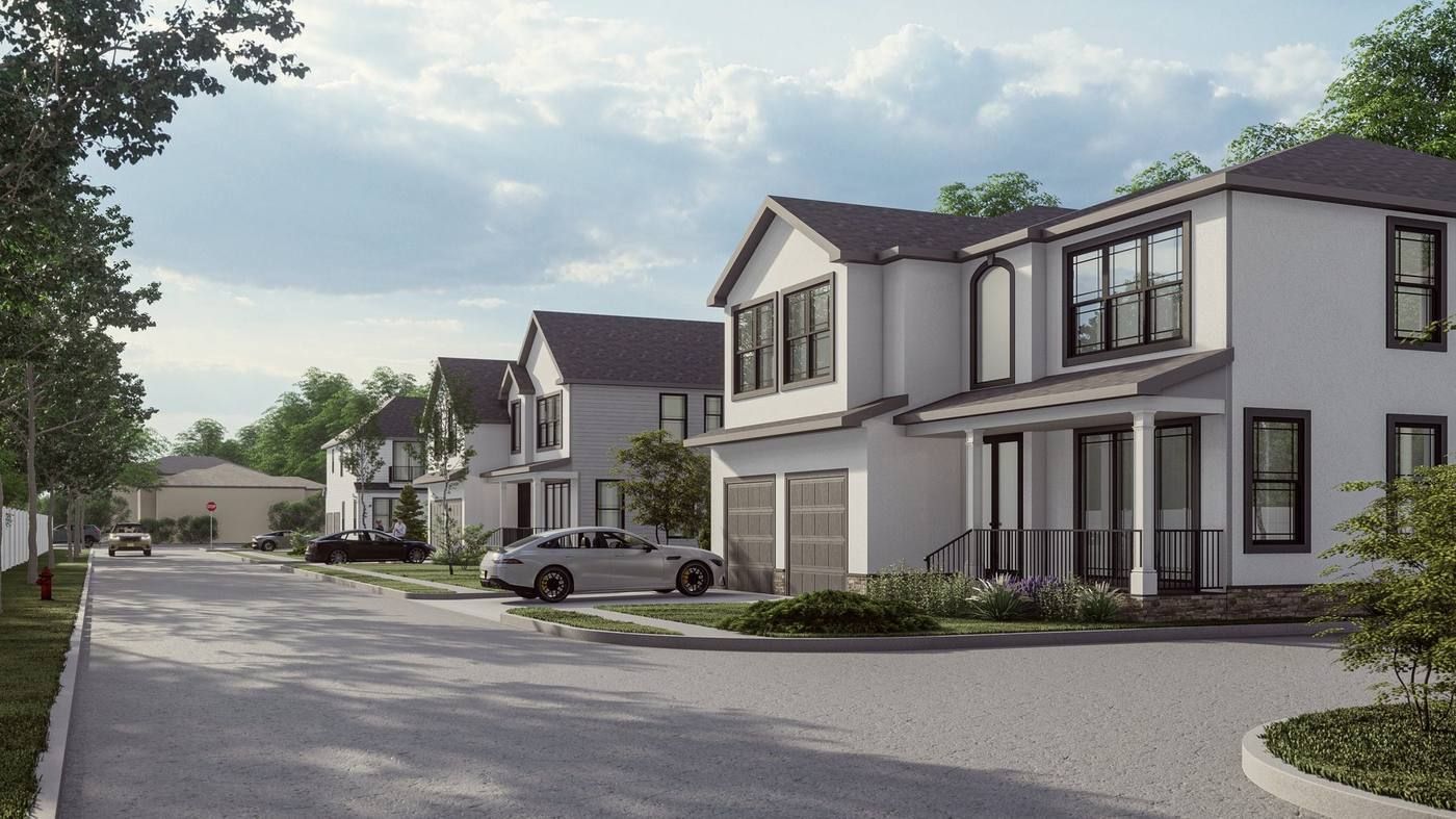 Suburban street with modern white houses, parked cars, and cloudy sky
