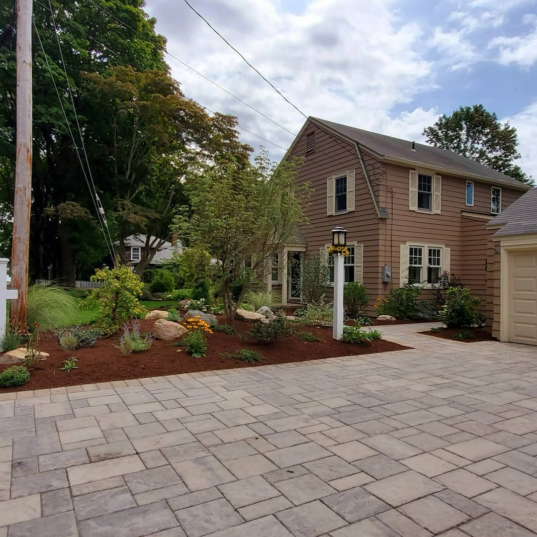 a large brick house with a large driveway in front of it