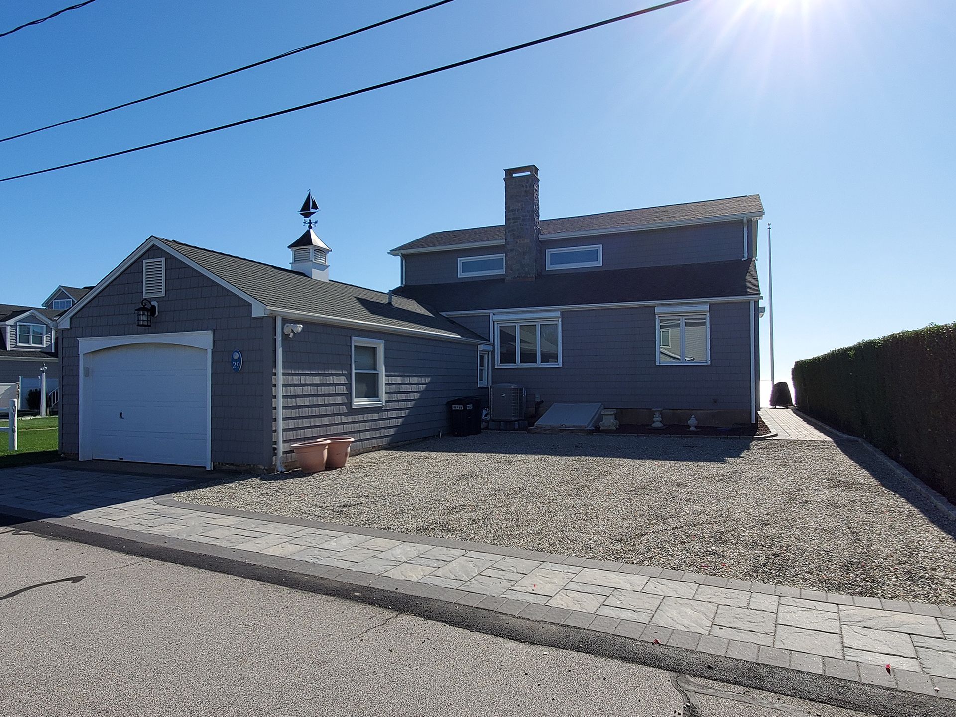 A house with a garage and a lighthouse on top of it