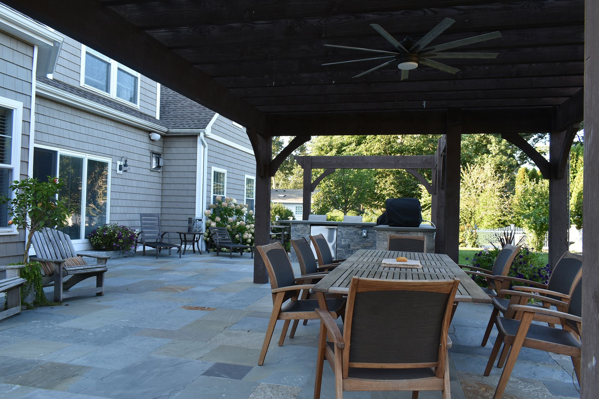A patio with a table and chairs under a pergola