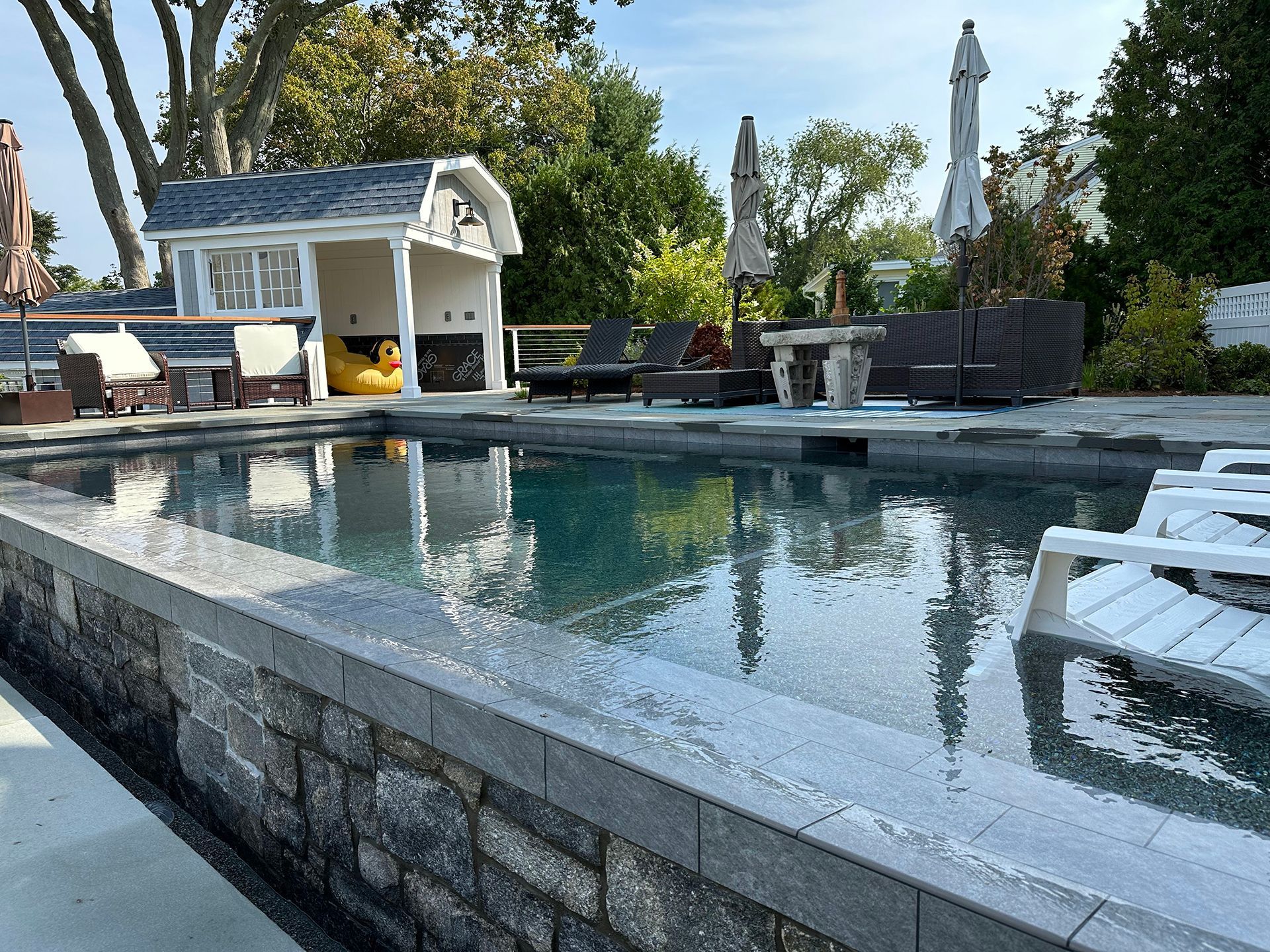 A large swimming pool with a shed in the background