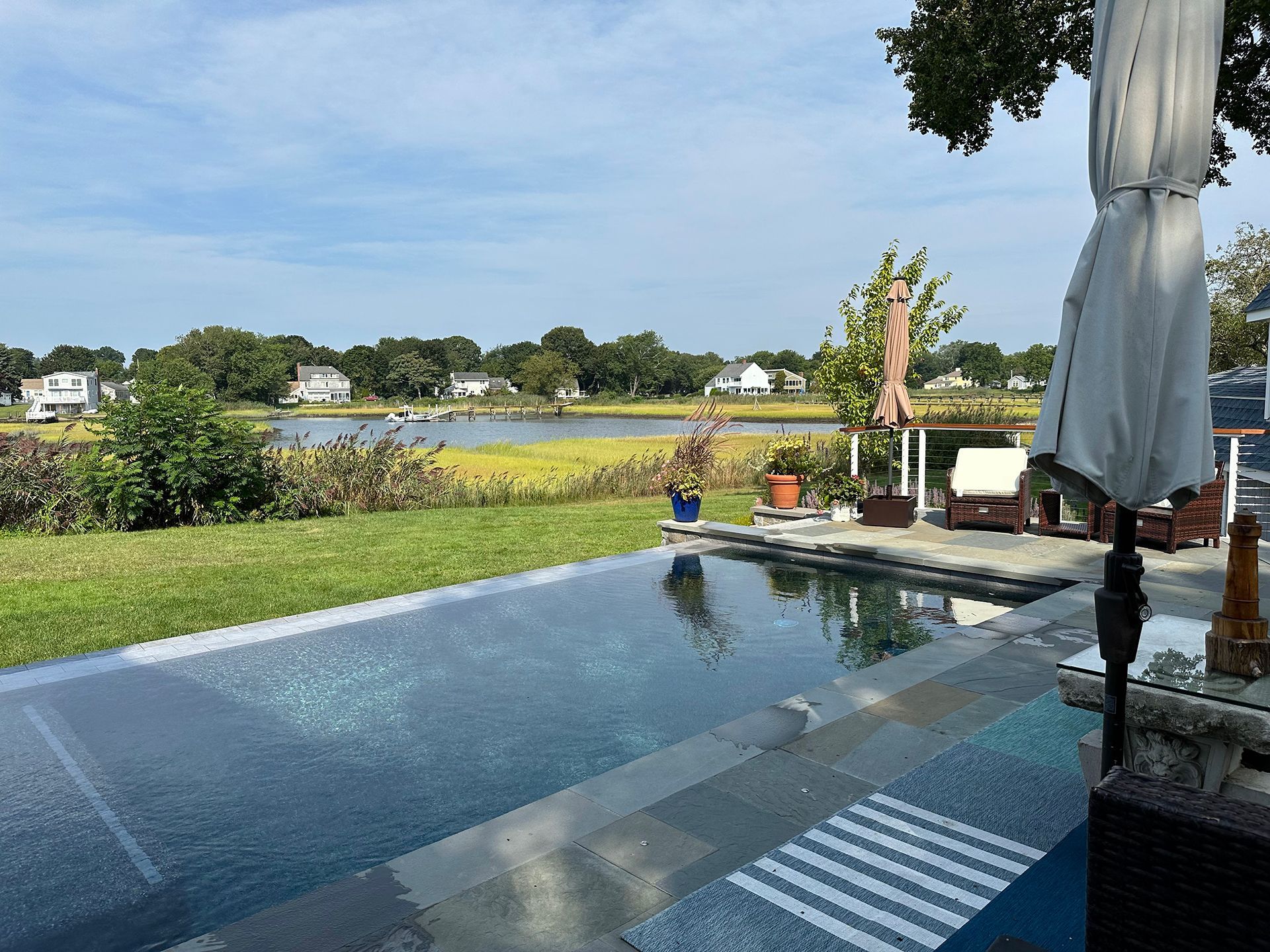 A large swimming pool with a view of a lake