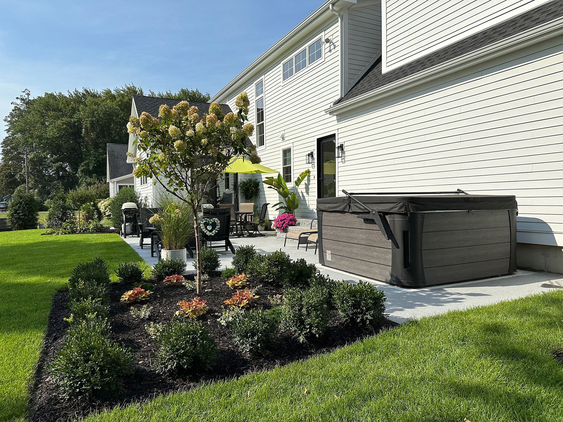 There is a hot tub in the backyard of a house.