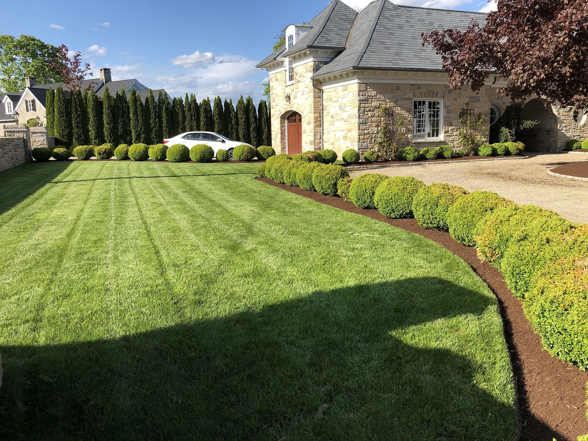 A large house with a lush green lawn in front of it.