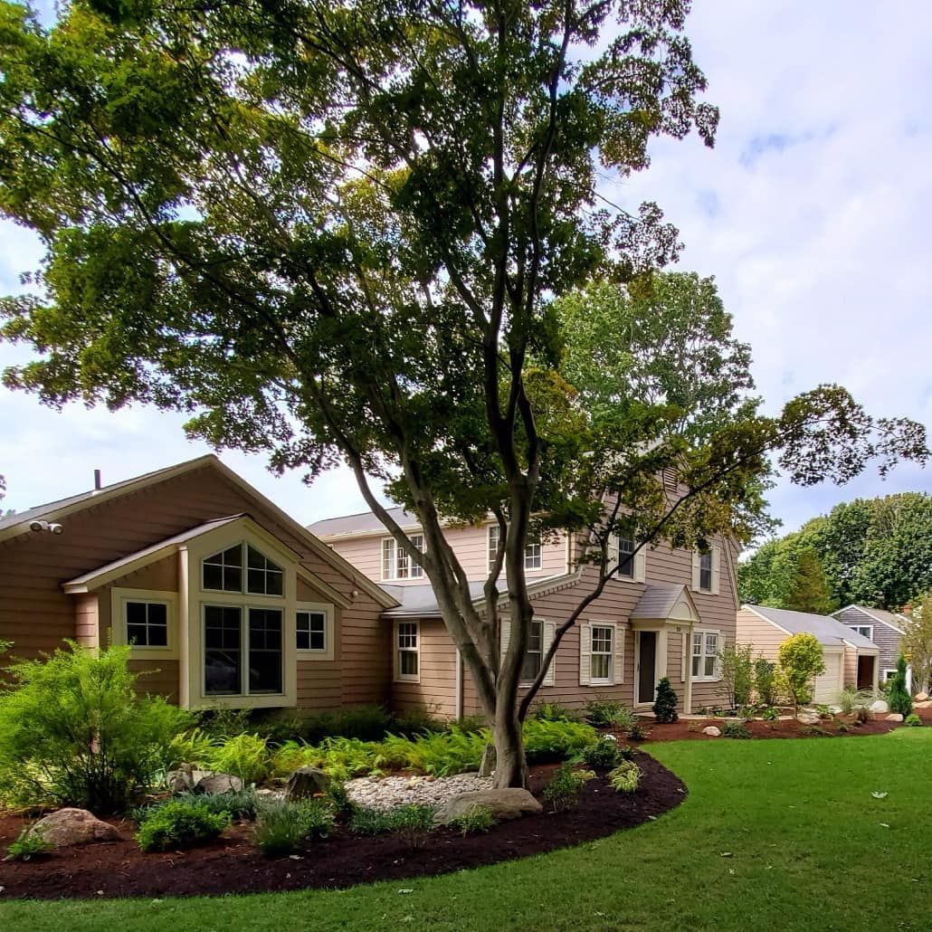 A house with a large lawn in front of it