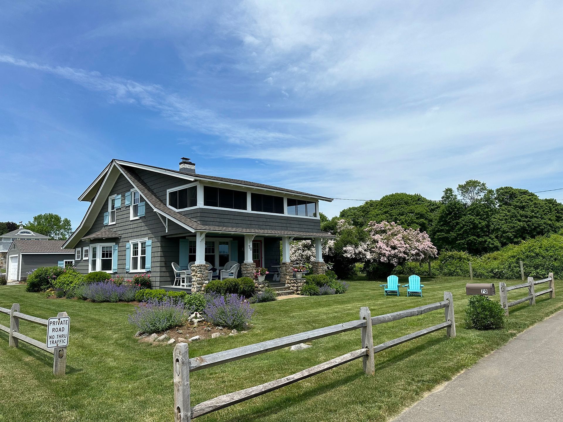 A large house with a wooden fence in front of it.