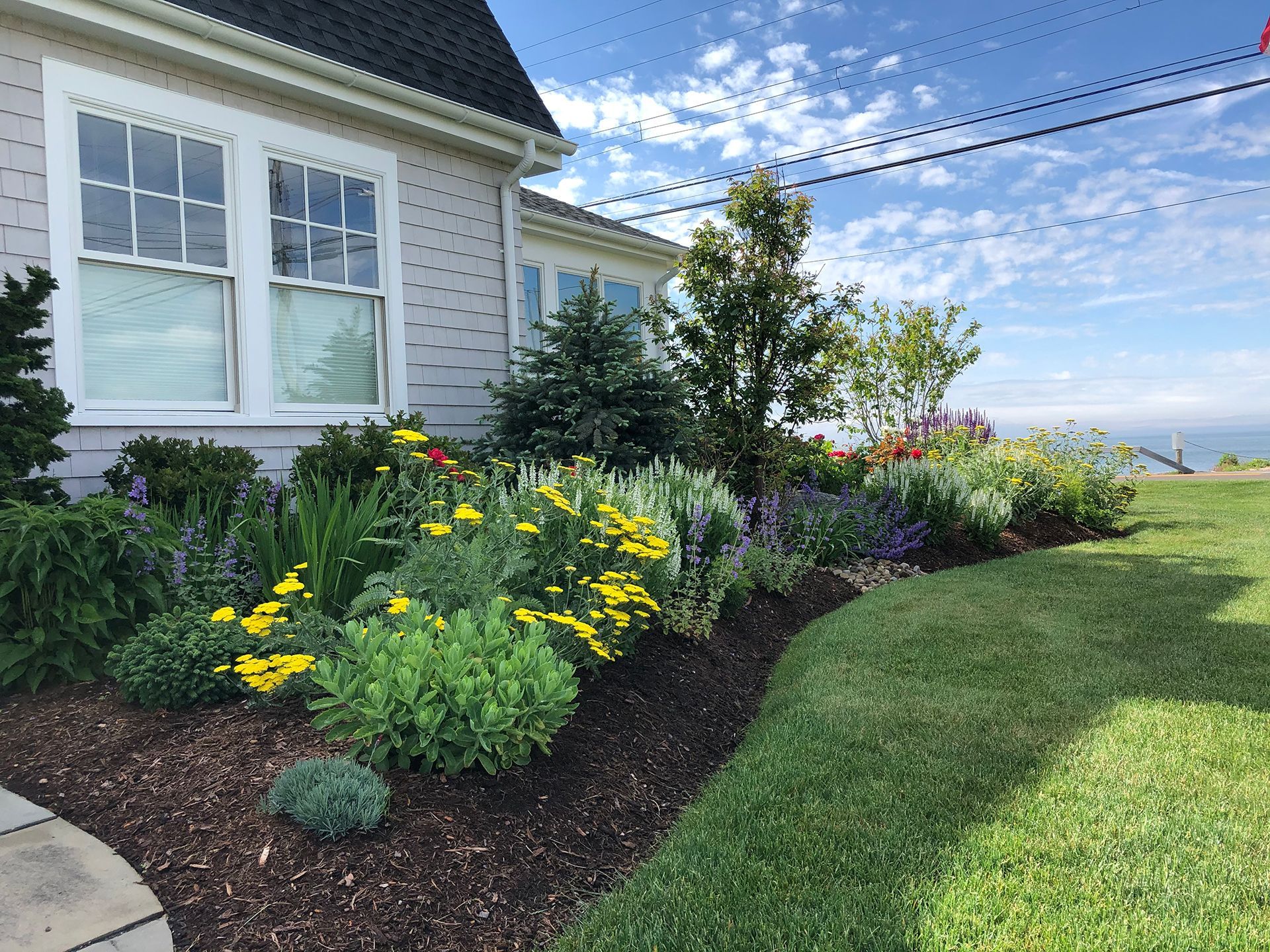 A house with a lot of flowers in front of it