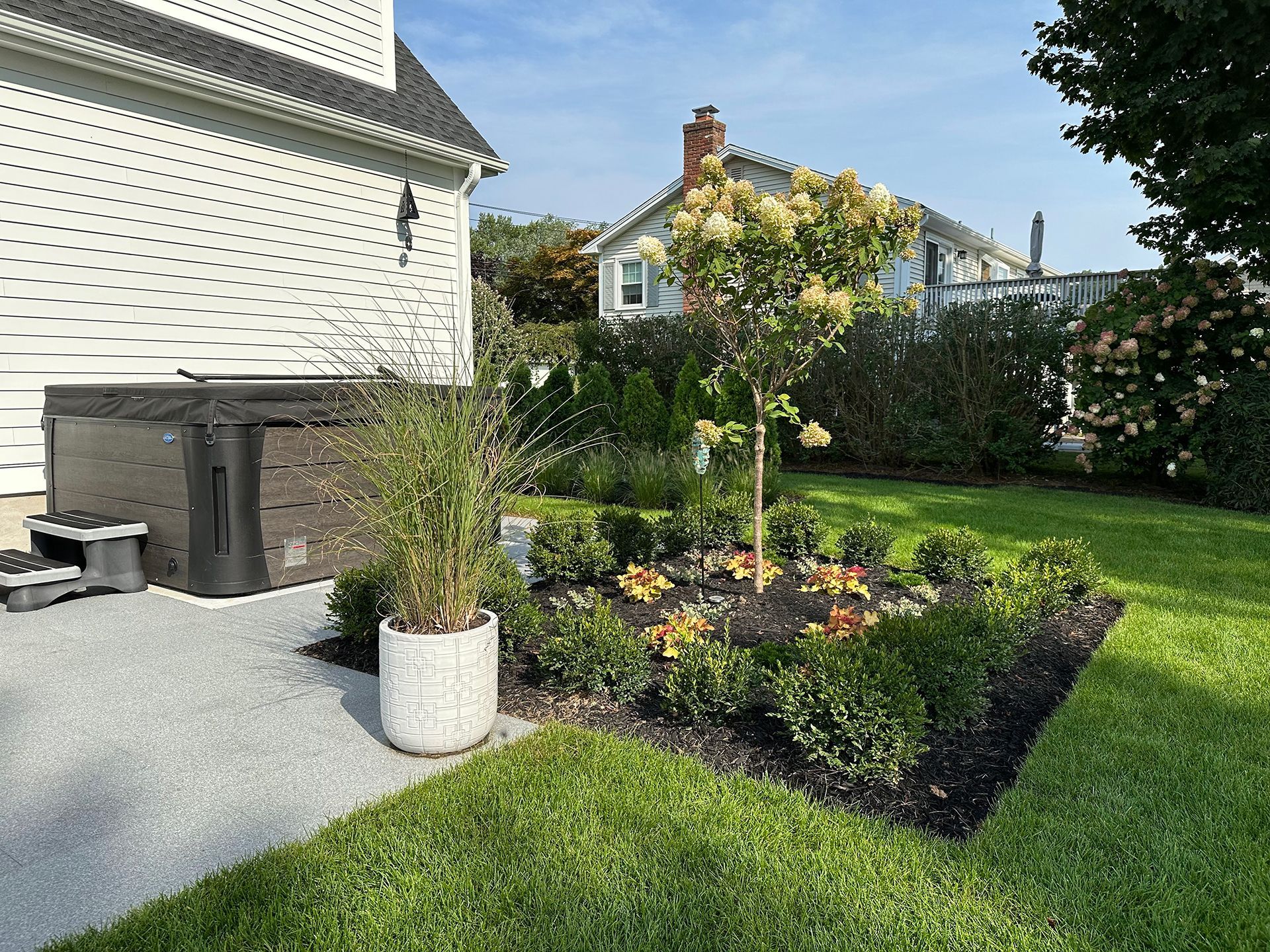 There is a hot tub in the backyard of a house.