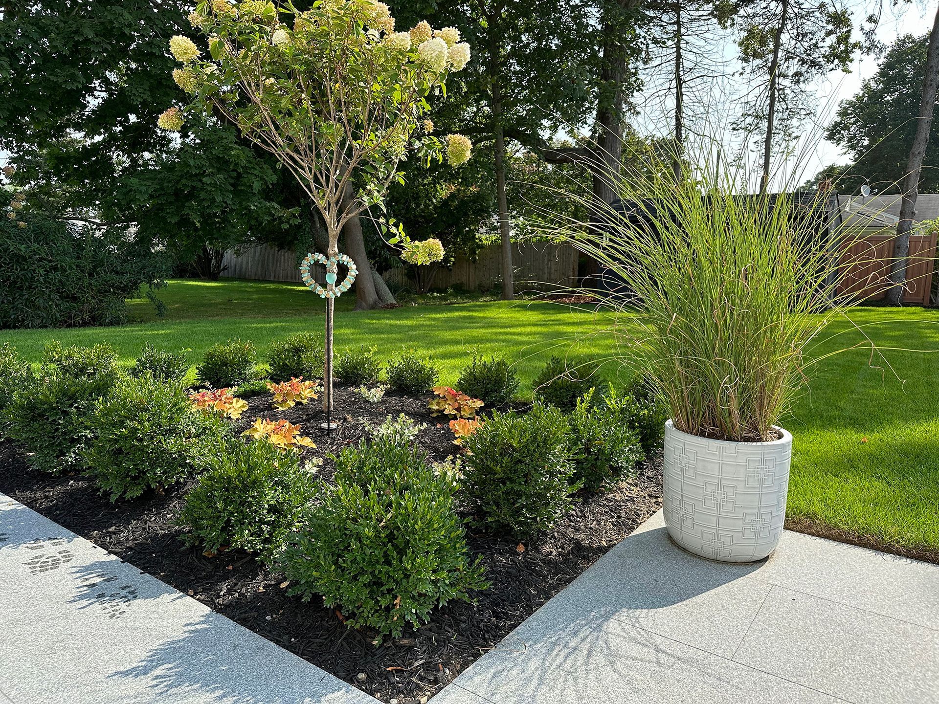 A potted plant is sitting in the middle of a garden.