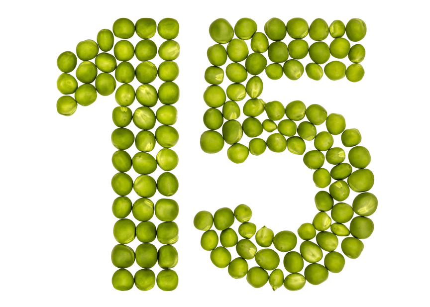 The number 15 is made of green peas on a white background