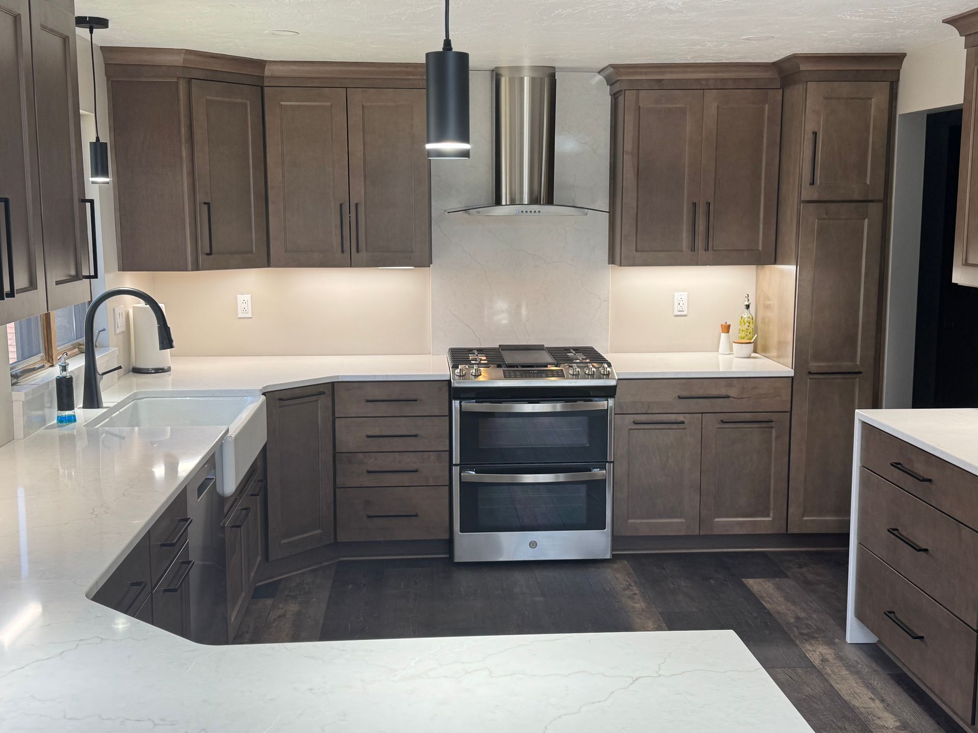 A kitchen with stainless steel appliances and wooden cabinets