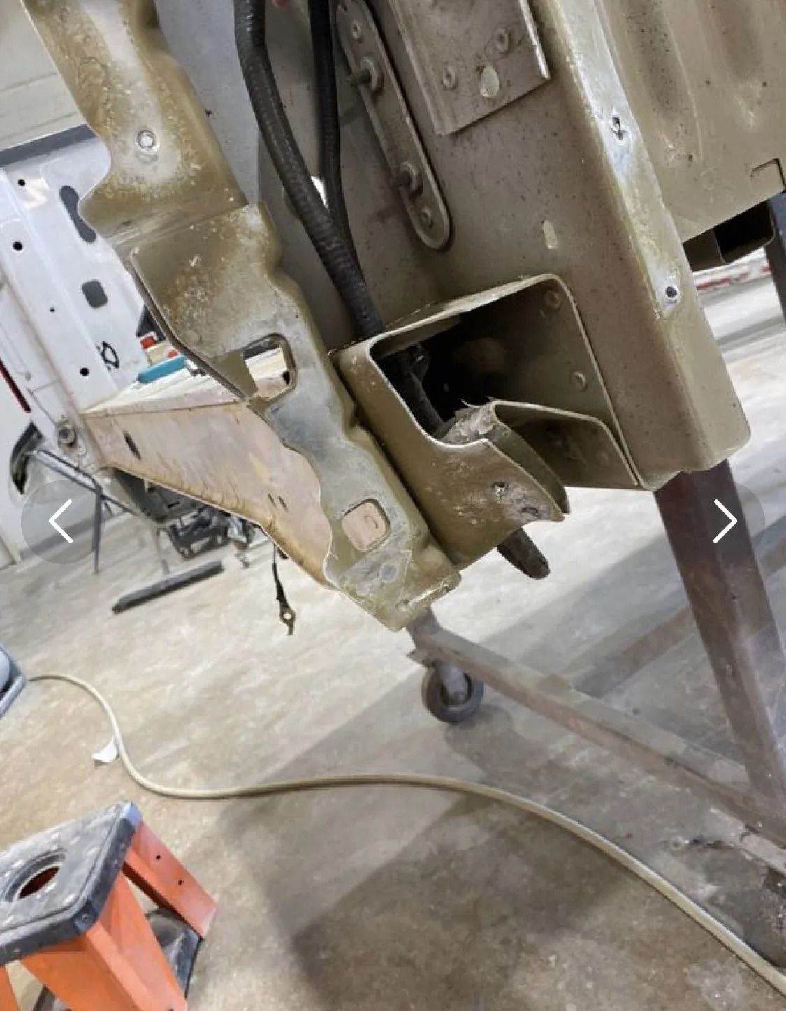 A white truck is parked in front of a building.