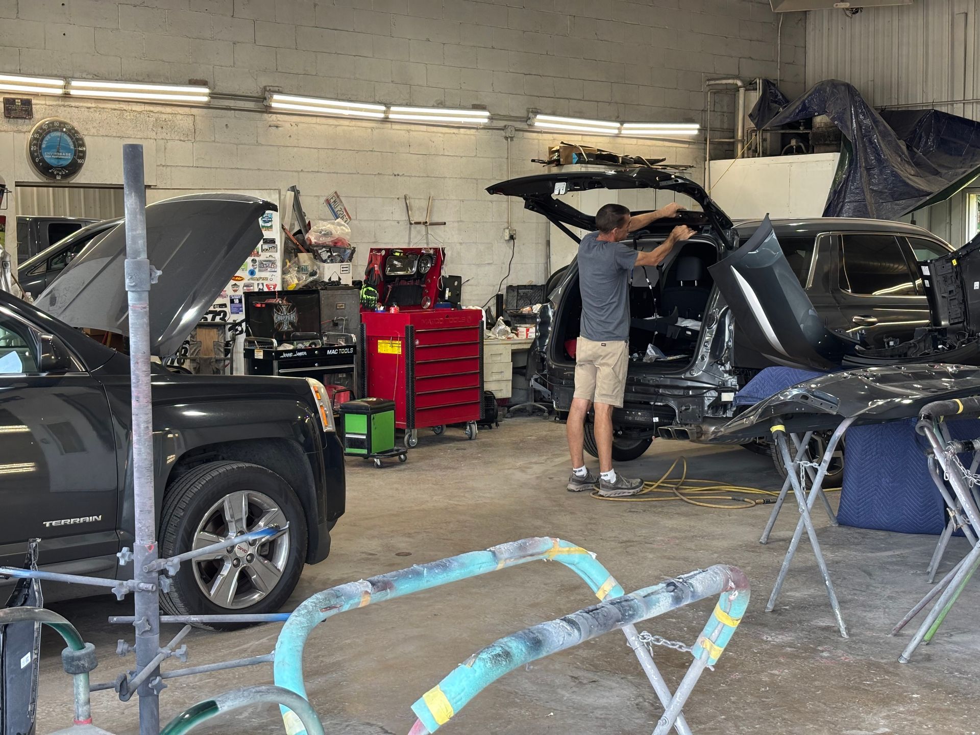 A man is working on a truck in a garage.
