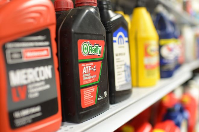 Row of colorful motor oil bottles on a store shelf