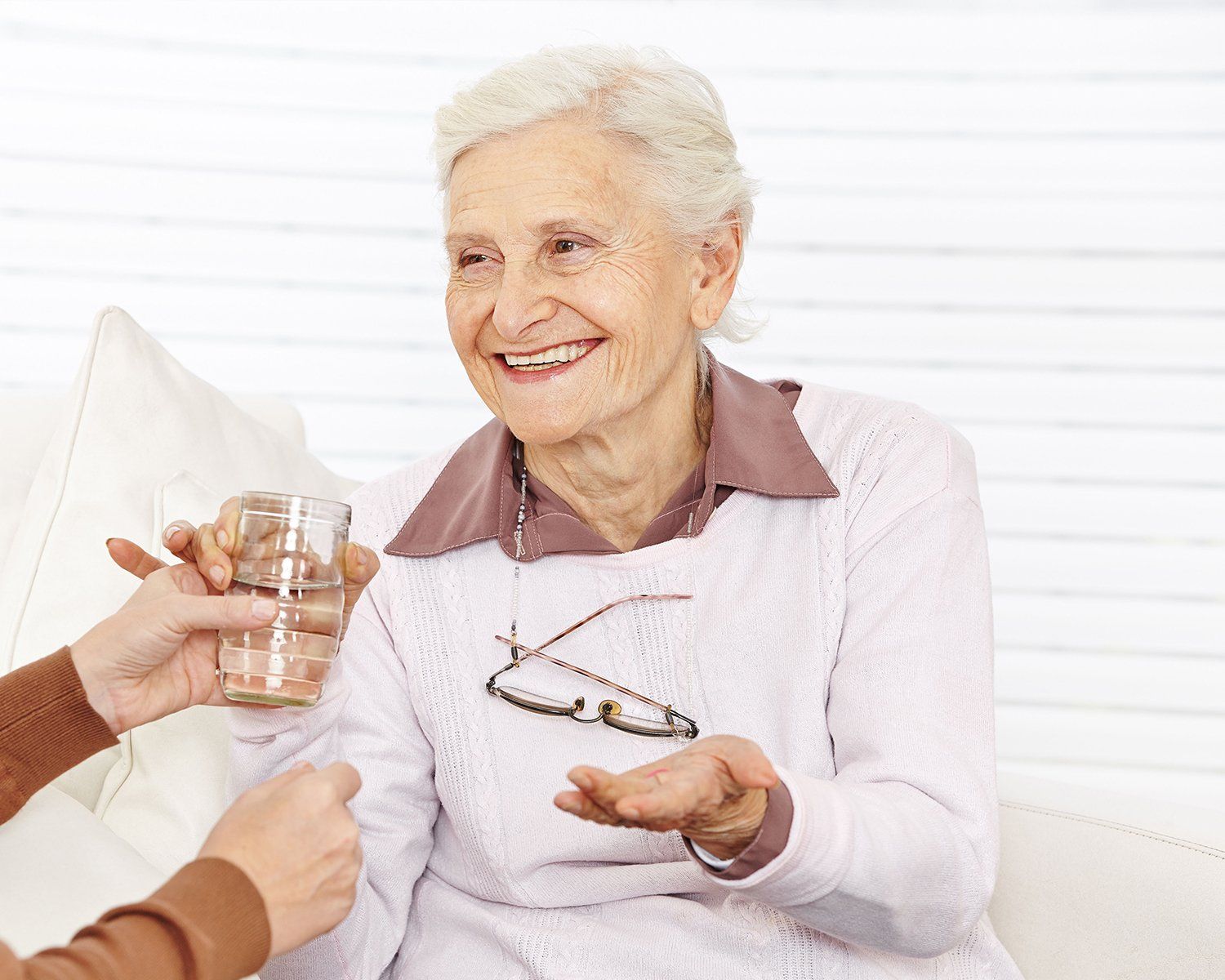 Senior drinking her medicine