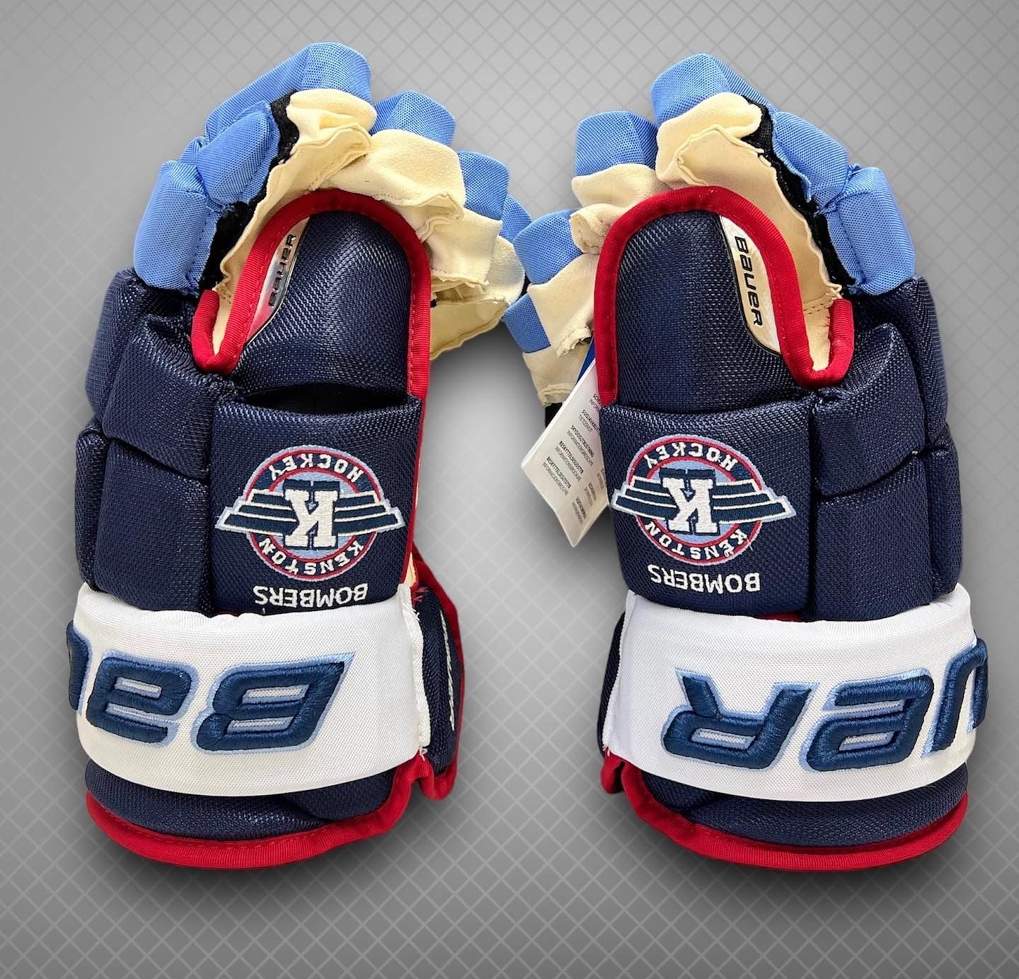 Pair of navy, white, and red hockey gloves with team logos, shown side by side on a gray background