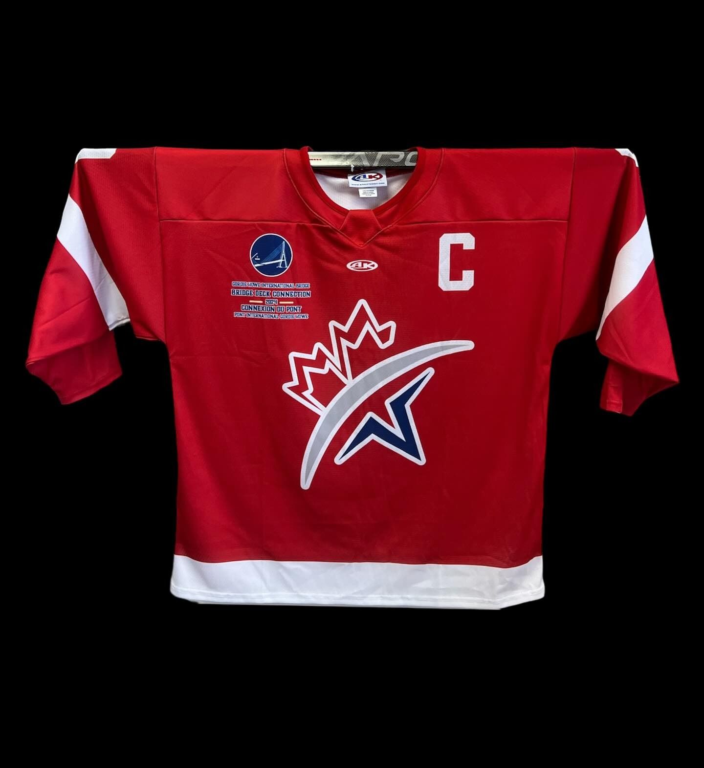 Red hockey jersey with white trim, a large crowned logo, and a white “C” on the chest.