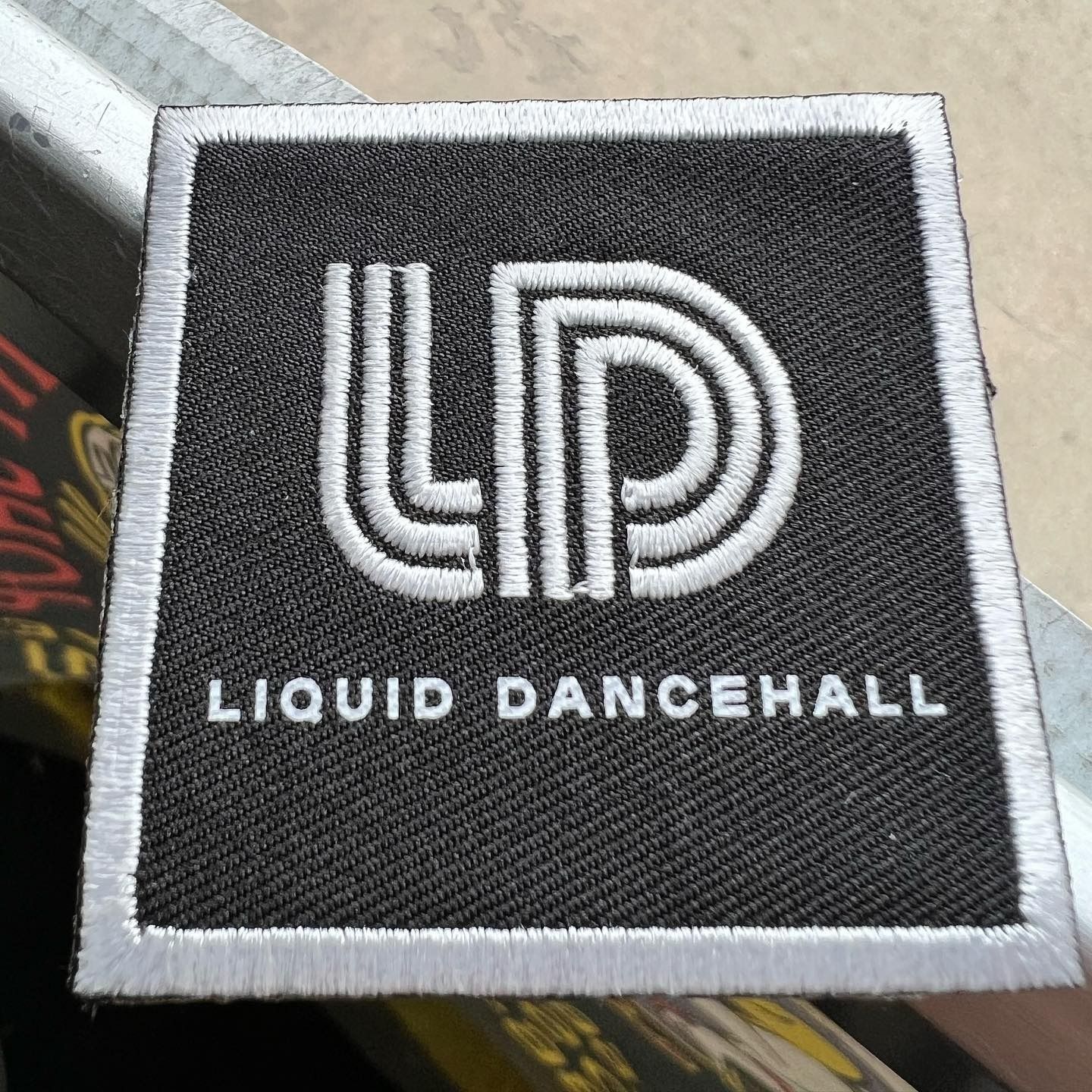 Black LIQUID DANCEHALL logo patch with white border and lettering