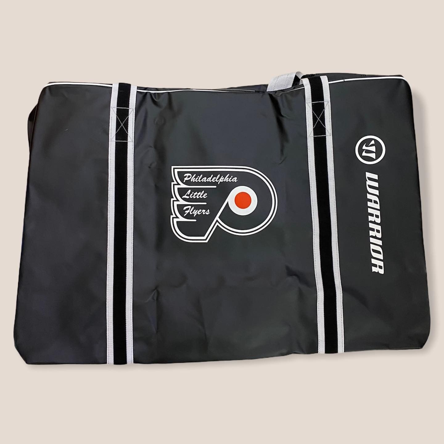 Black Philadelphia Flyers duffel bag with white zippers and logo, shown closed on a plain background