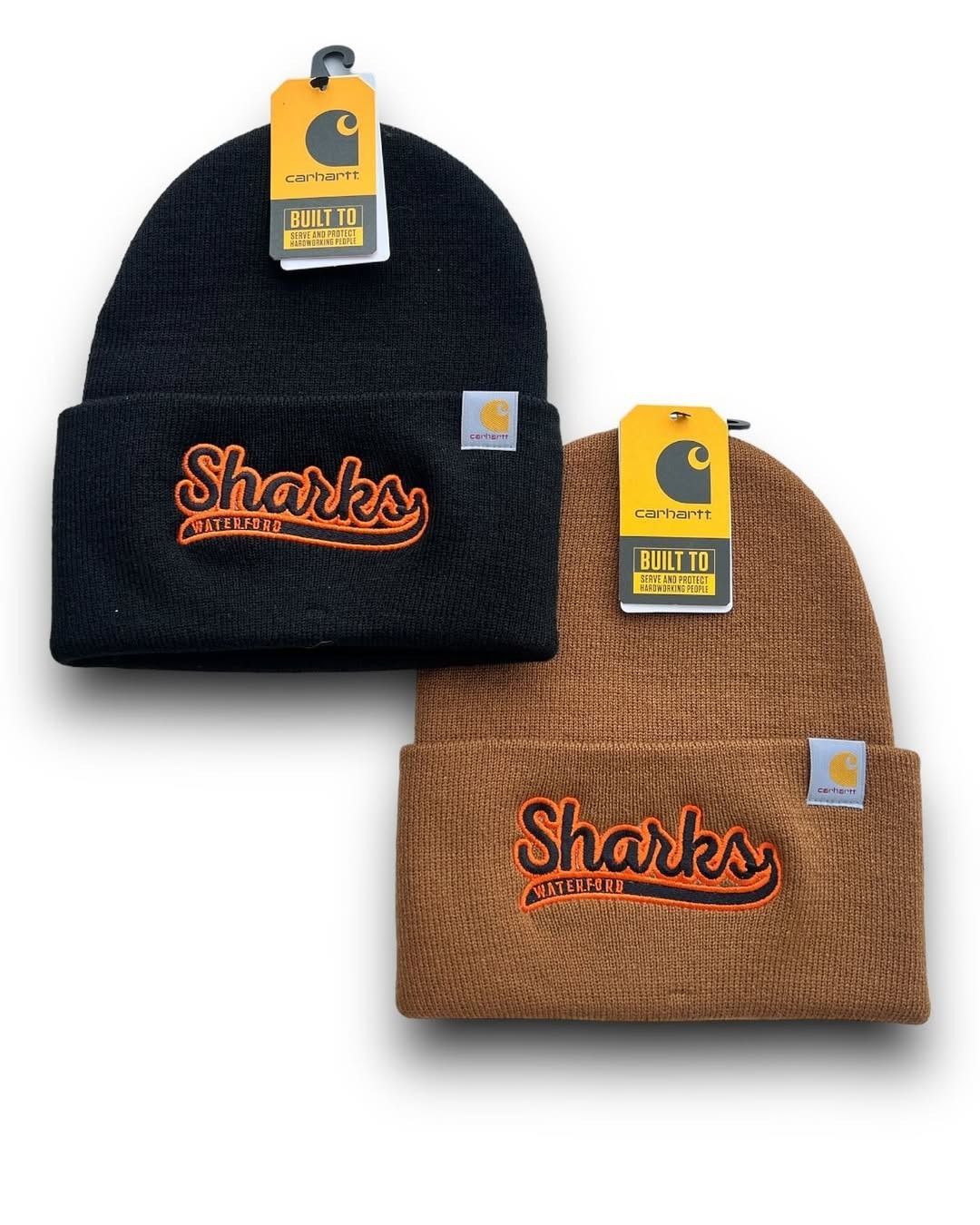 Two Sharks beanies, one black and one brown, displayed with tags on a white background