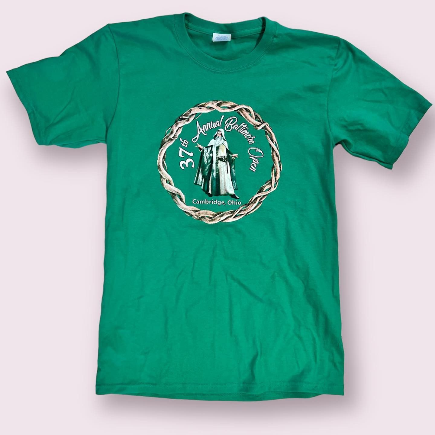 Green T-shirt with a circular graphic of a robed figure at the center
