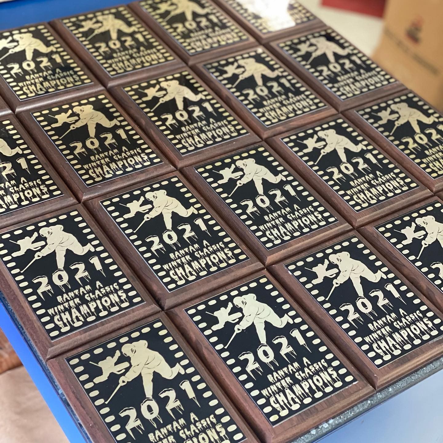 Tray of square dark chocolate bars with gold 2021 marathon-themed designs