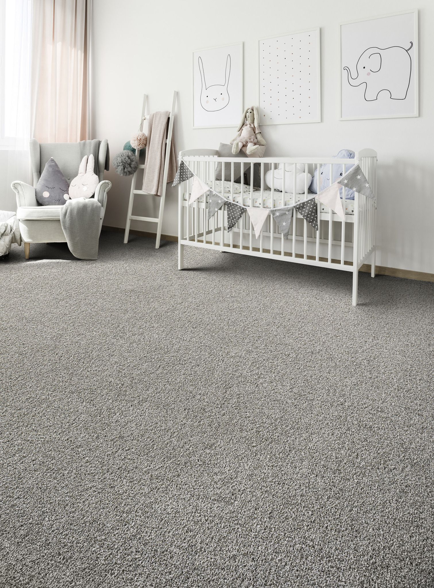 a baby room with a crib, chair, and gray carpet